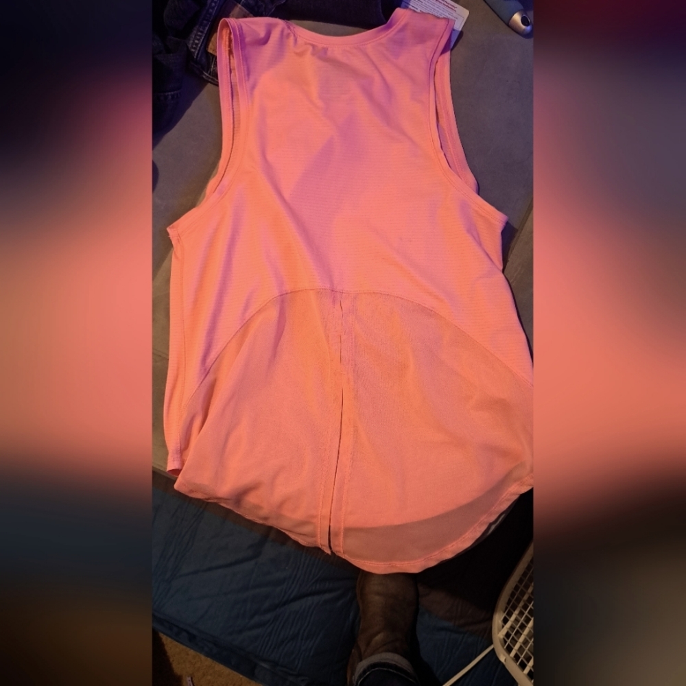 Pink shirt feels silky . Mystical coral color size small workbout type